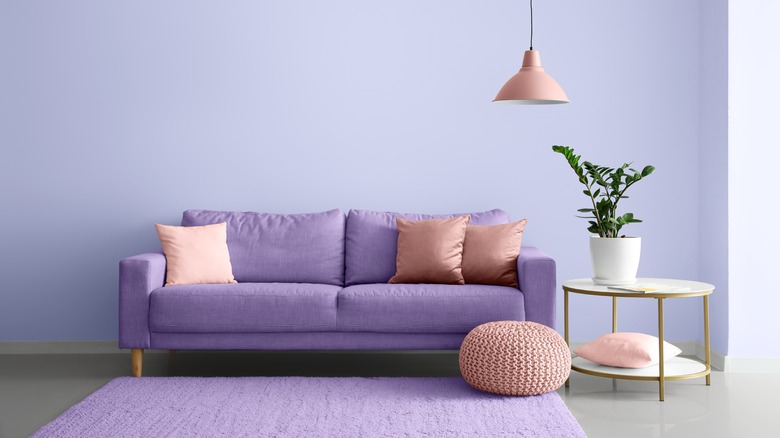 Lavender couch and walls with pink accents.