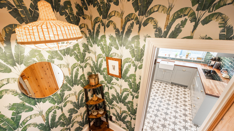 Palm leaf wall paper with wood accents.