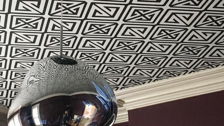 A black and white ceiling wallpaper and lighting fixture.