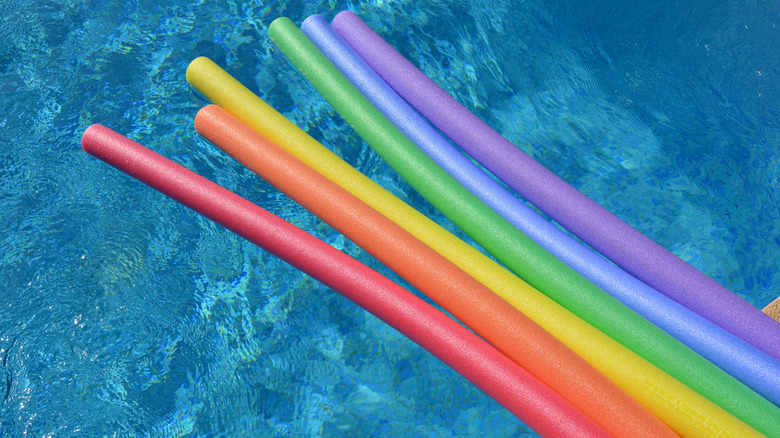 colorful pool noodles in pool