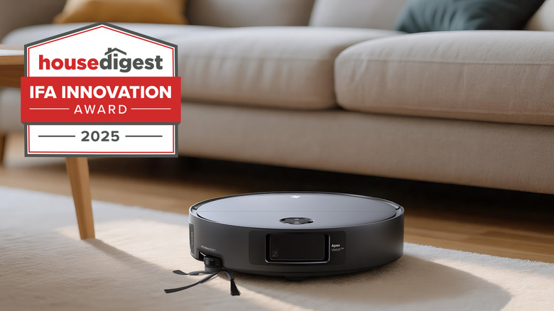 A 3i Q10 Ultra robot vacuum sitting on a rug by a couch