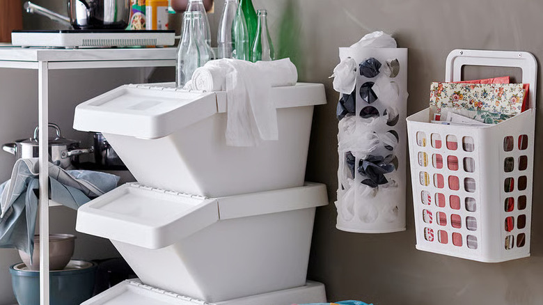 White plastic bag dispenser in a cluttered kitchen