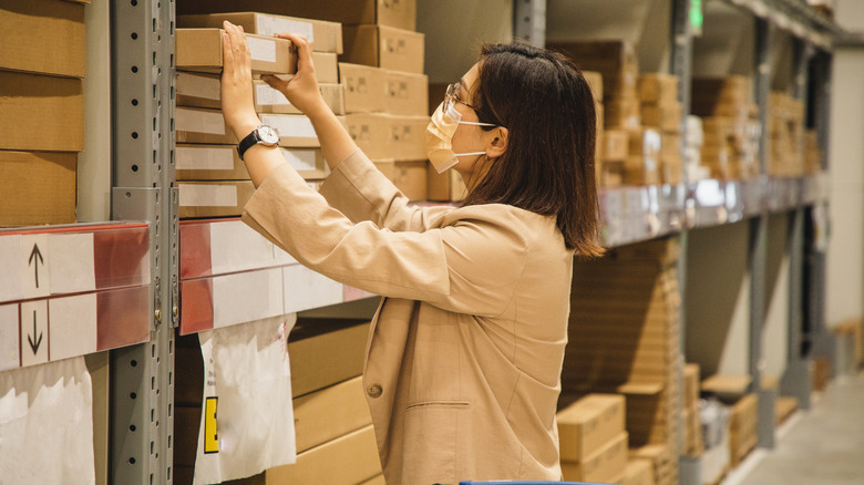 Woman examining products on shelf