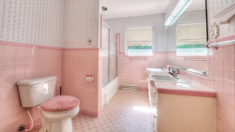 pink tiled bathroom with wallpaper