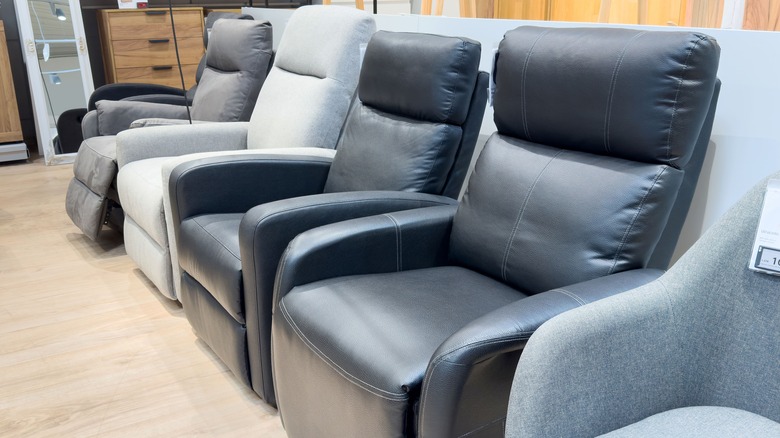 Modern recliner chairs displayed in furniture store showroom.