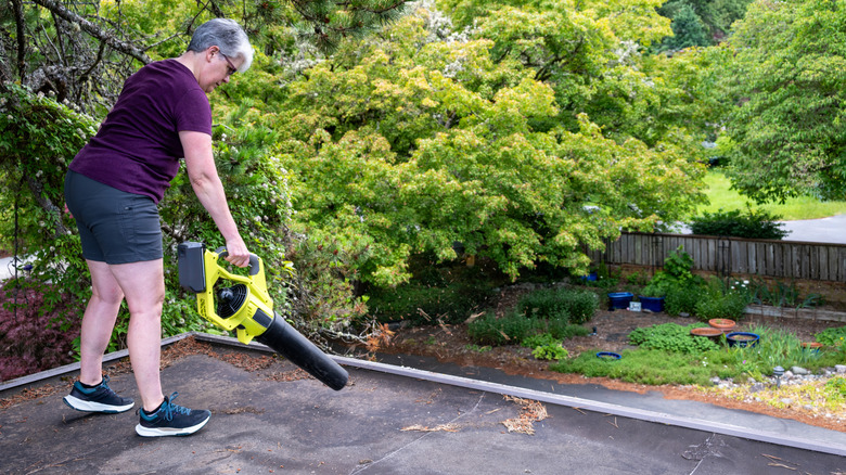 Woman using a large leaf blower