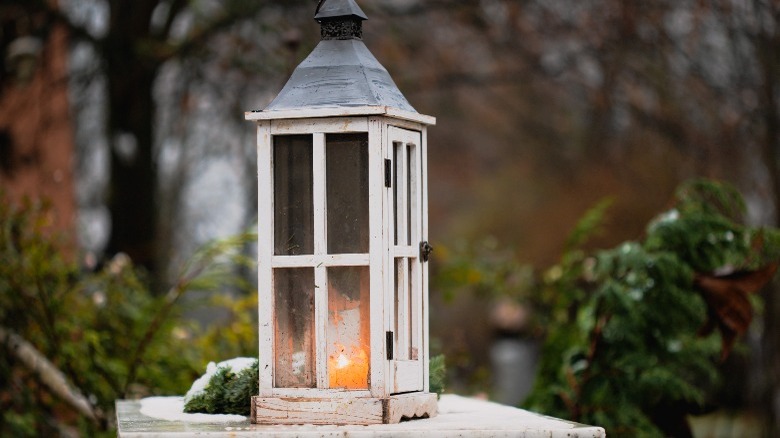 lit wooden lantern at dusk