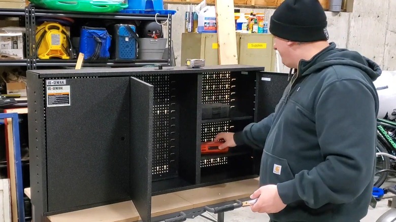 Man filling tool cabinet from Harbor Freight