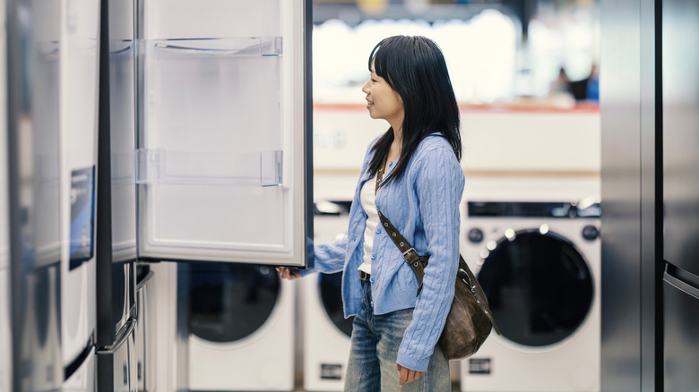 A woman shopping for a refrigerator in an appliance store
