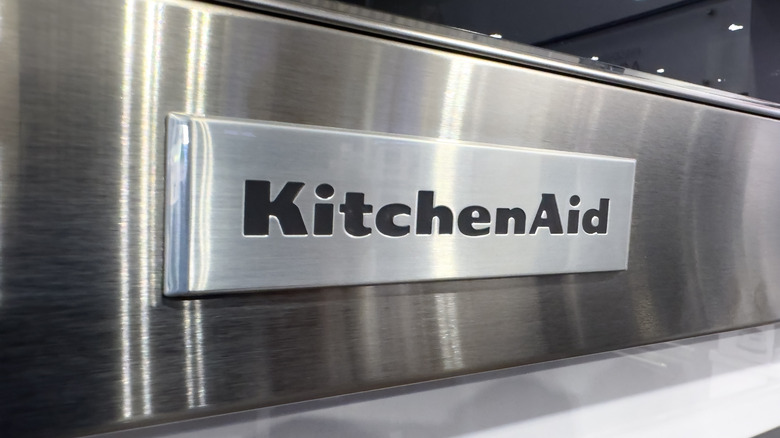 A KitchenAid logo on a stainless steel appliance