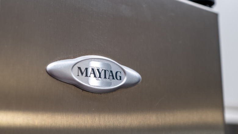 A Maytag logo on a stainless steel refrigerator