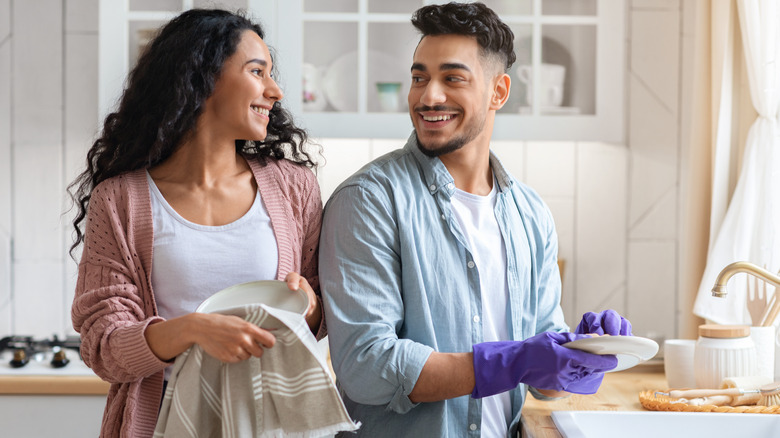 happy couple doing dishes