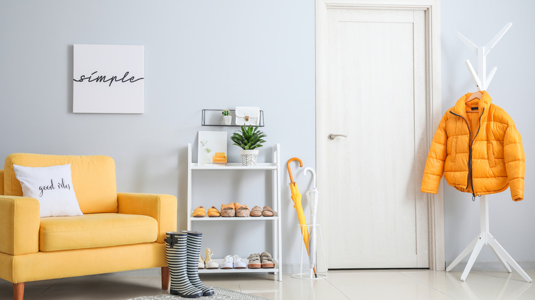 organized entryway with yellow decor