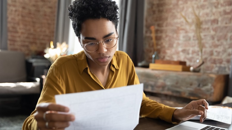 Woman reading home insurance documents