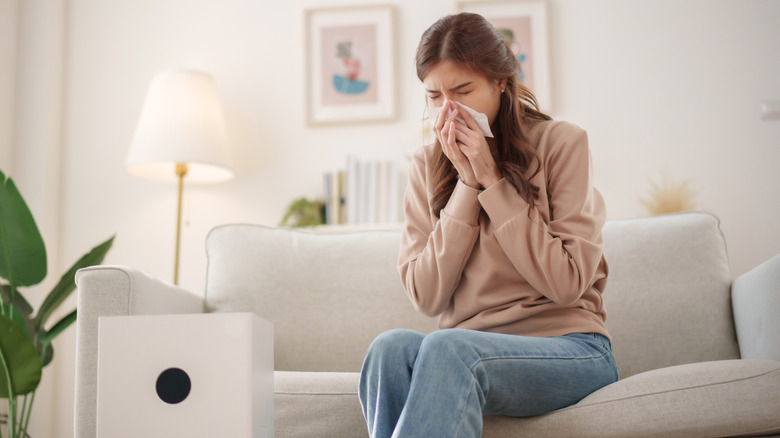 woman sneezing from poor indoor air quality