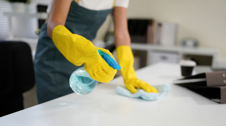 hands cleaning countertop