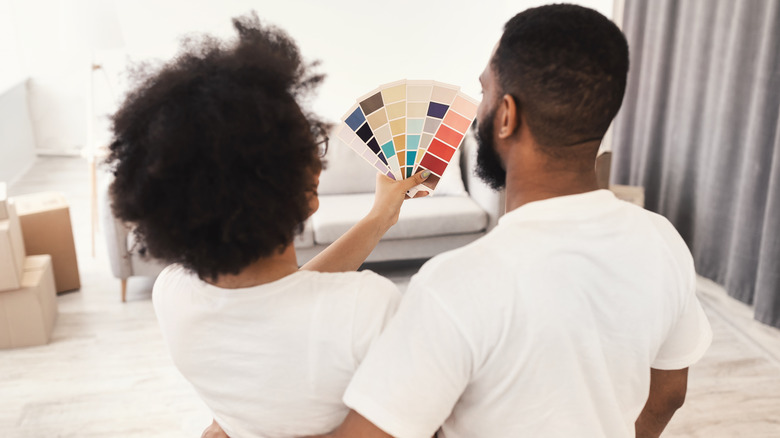 family choosing paint color for walls 