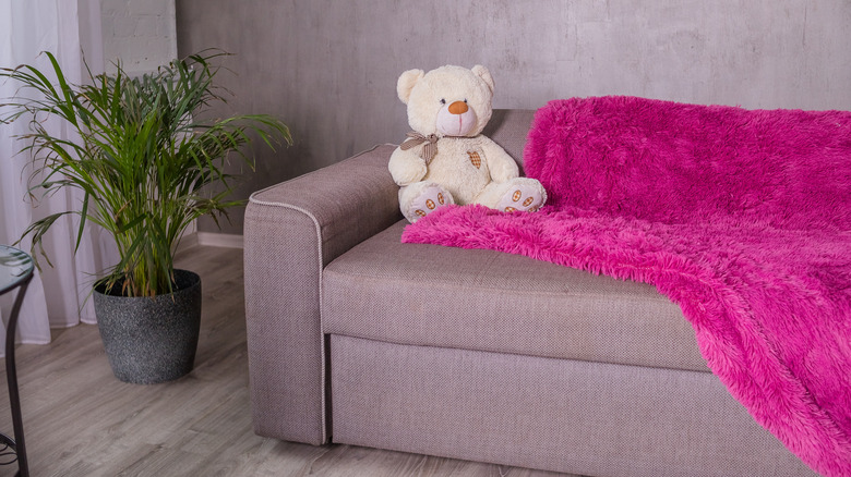 teddy bear on fuchsia blanket