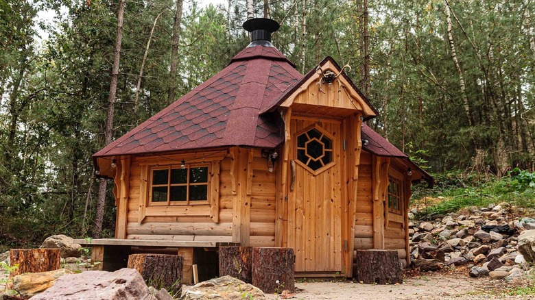 uniquely shaped cabin with trees