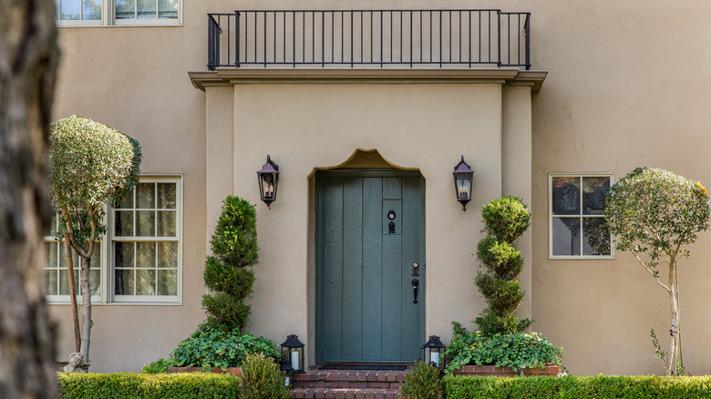 tan home with blue door