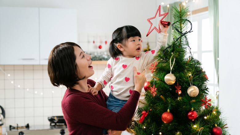 Mother and child decorating tree