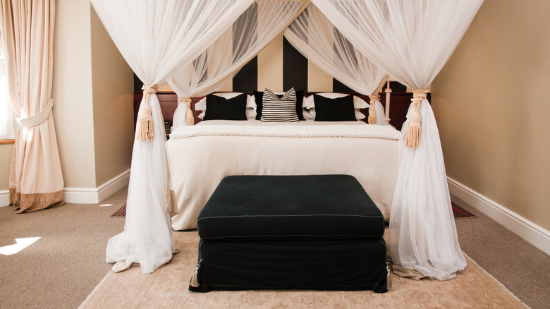 cream walls with black bedding