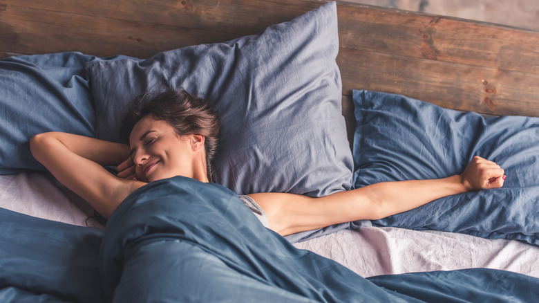 Woman in bed with blue bedding