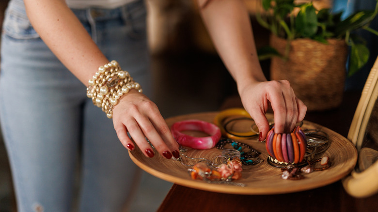 Woman selecting jewelry from a tray