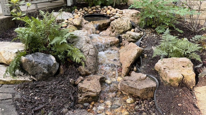 Front yard rock garden with small pond and waterfall