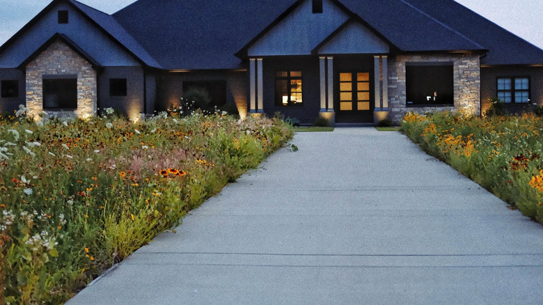Home with wildflower meadow split by wide walkway