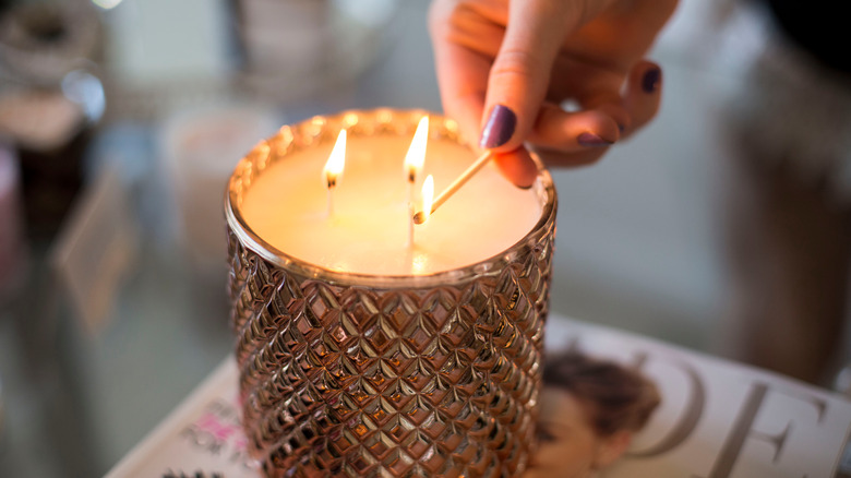 Person lighting candle