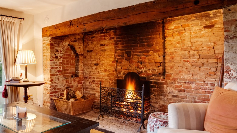 brick fireplace with wood beam