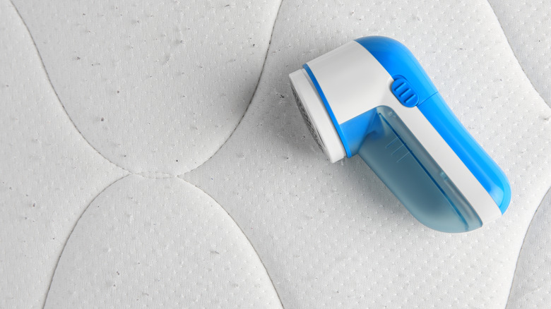 A fabric shaver laying on a pilling mattress.