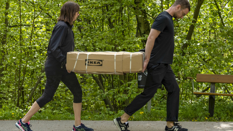 Couple carrying an IKEA box