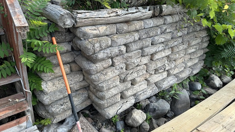 Small retaining wall made from concrete bags.