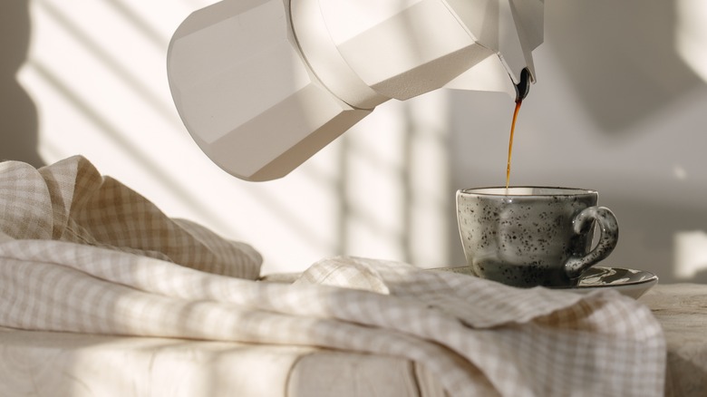 pouring coffee into mug