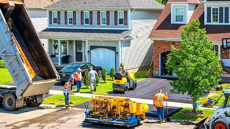 Workers pouring a new asphalt driveway