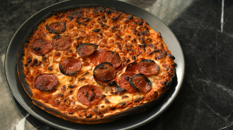 burnt pizza on plate