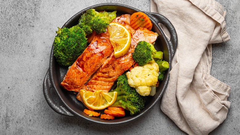 Fish and lemons in pan