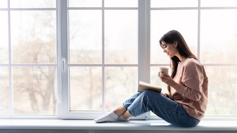 girl sitting on window sill