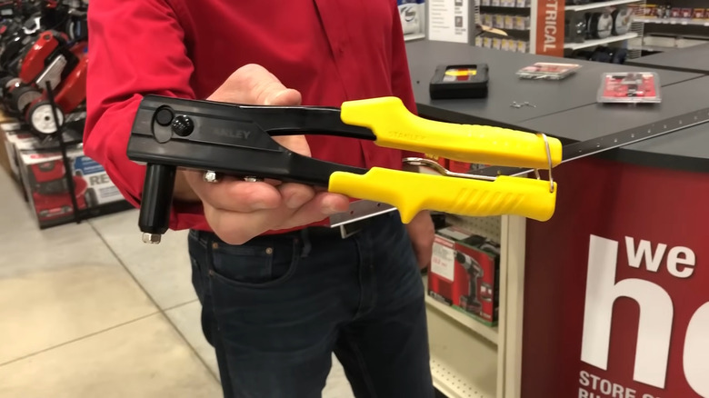 an Ace associate demonstrates how to use a hand rivet tool