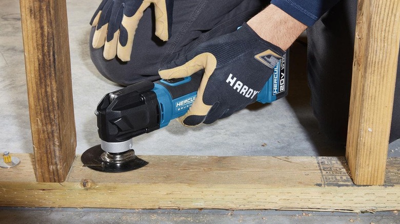 A person using the Hercules oscillating multi-tool on a piece of wood