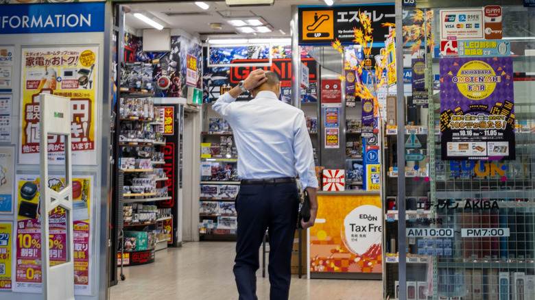 A confused man walking into a store in Japan