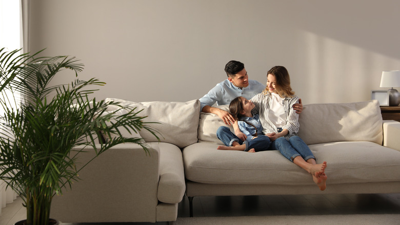 family sitting on raised couch
