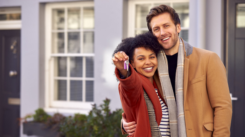 happy couple holding house keys