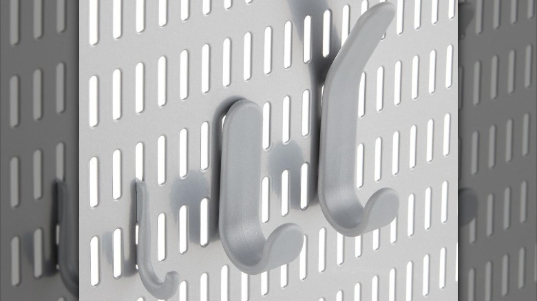 three gray plastic utility hooks