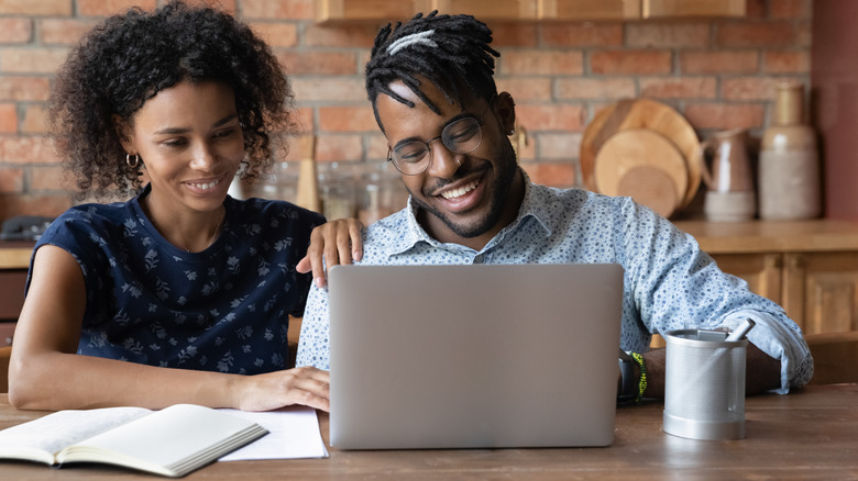 couple planning reno on laptop