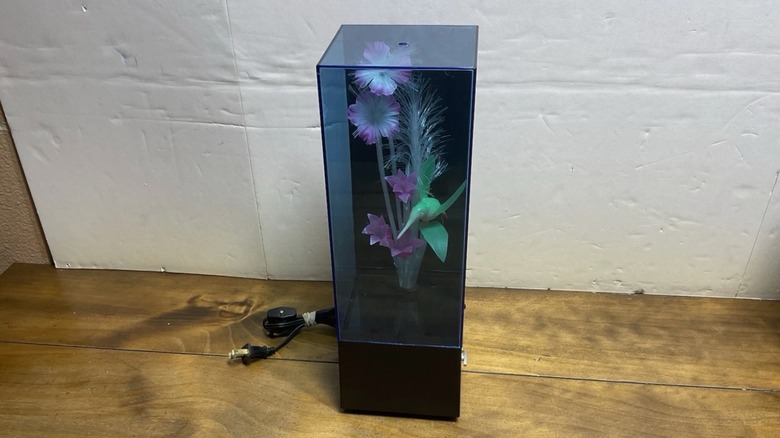 A fiber optic lamp with a floral design in a case