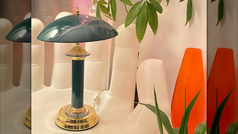 A brass lamp with a saucer-shaped shade