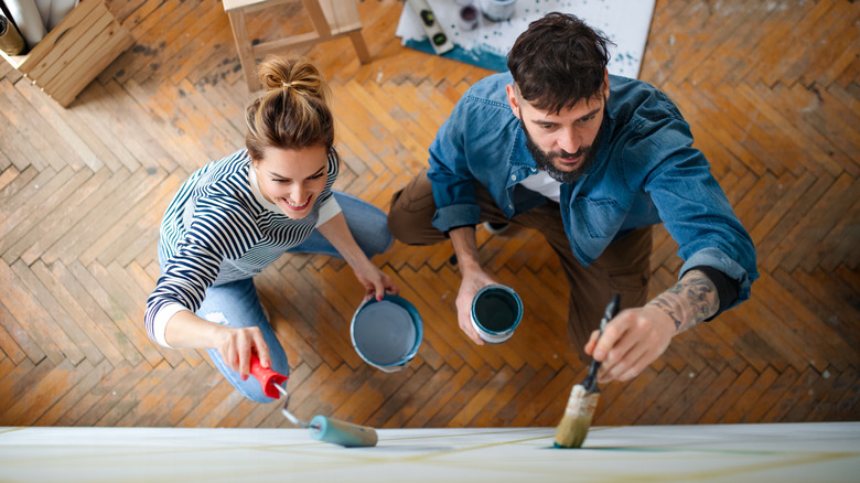 couple painting wall